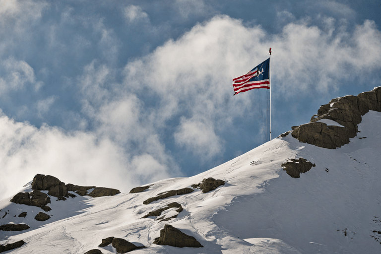 Massachusetts flag framed by majestic mountains: Fun Facts await!